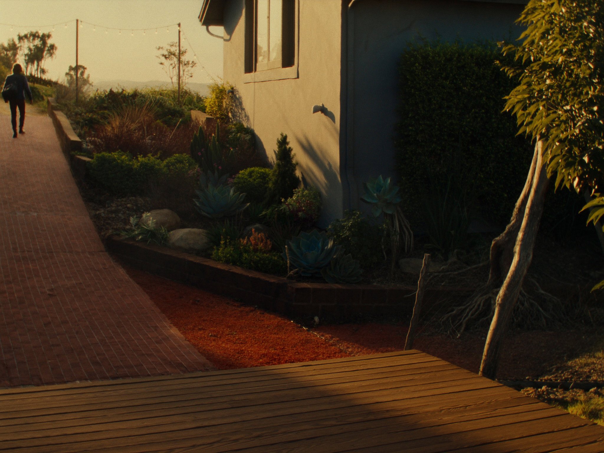 Backyard patio with wood deck and garden landscaping